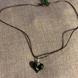 Green heart glass on black necklace